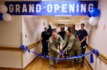 Capt. Daniel Clark (left), commanding officer of Naval Hospital Twentynine Palms, and Cmdr. Christine Higgins (right), Maternal-Infant Nursing Department head and staff certified nurse midwife, cut the ribbon during a ceremony on May 29 marking the relocation and revitalization of the hospital’s Multi-Service Ward. The upgraded space, which houses the Maternal Infant Nursing Department (MIND), enhances inpatient care for military families aboard the Marine Corps Air Ground Combat Center (U.S. Navy photo by Christopher C. Jones, NHTP/NMRTC Twentynine Palms public affairs officer).