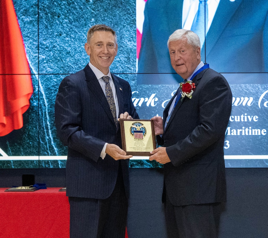 Mark Brown receives his Hall of Fame award from DLA Land and Maritime Acting Commander Kenneth Watson