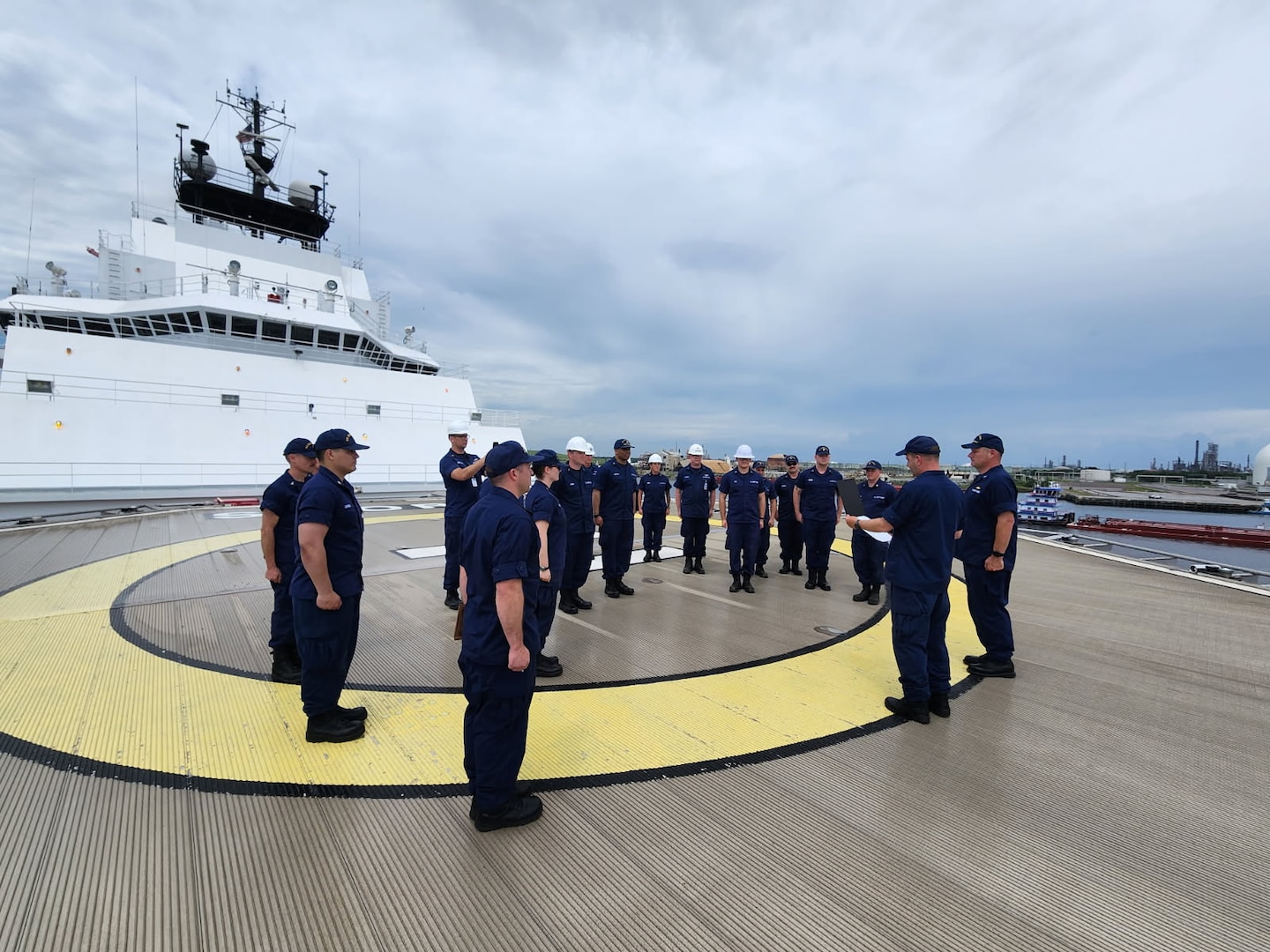 Capt. Keith Ropella reads his orders to assume command of the USCGC Storis during quarters on the cutter’s forward flightdeck.