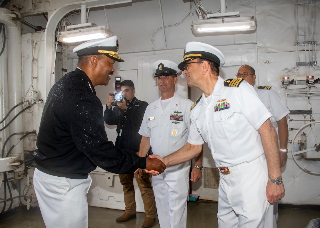 Admiral Alvin Holsey shakes hands with Captain Stephen Arles