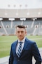 Man in a suit poses for a portrait style photo