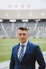 Man in a suit poses for a portrait style photo