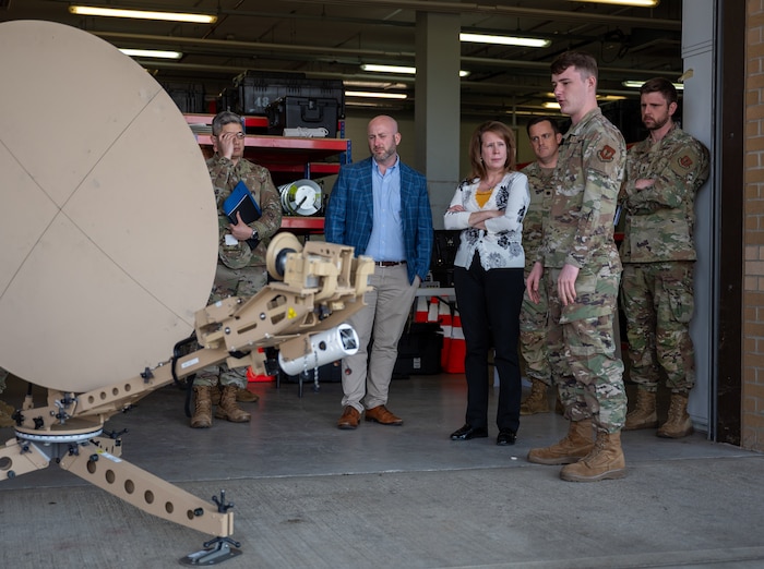 A group of individuals look at satellite equipment