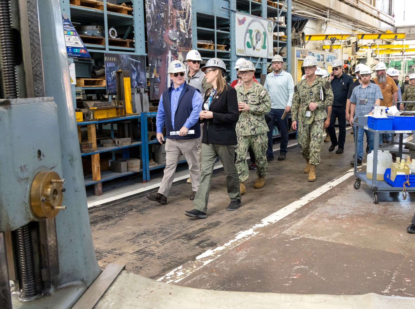 Secretary of the Navy John C. Phelan tours building 431, with Capt. JD Crinklaw, commander, Puget Sound Naval Shipyard & Intermediate Maintenance Facility and Felicienne Griffin, superintendent, Shop 31, Inside Machinists, leading, during a visit to PSNS & IMF May 28, 2025, in Bremerton, Washington. (U.S. Navy photo by Wendy Hallmark)