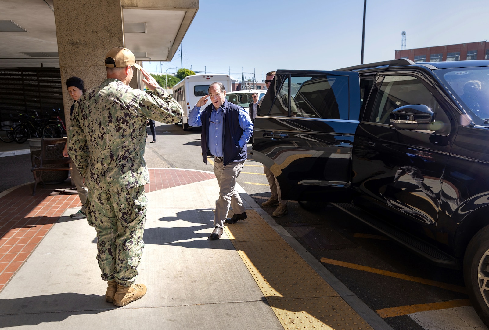 New Secretary of the Navy John Phelan is greeted with a salute from Capt. JD Crinklaw, commander, Puget Sound Naval Shipyard & Intermediate Maintenance Facility, upon his arrival for a command visit, May 28, 2025, in Bremerton, Washington. Phelan was briefed by senior leadership and toured command operations. (U.S. Navy photos by Wendy Hallmark)
