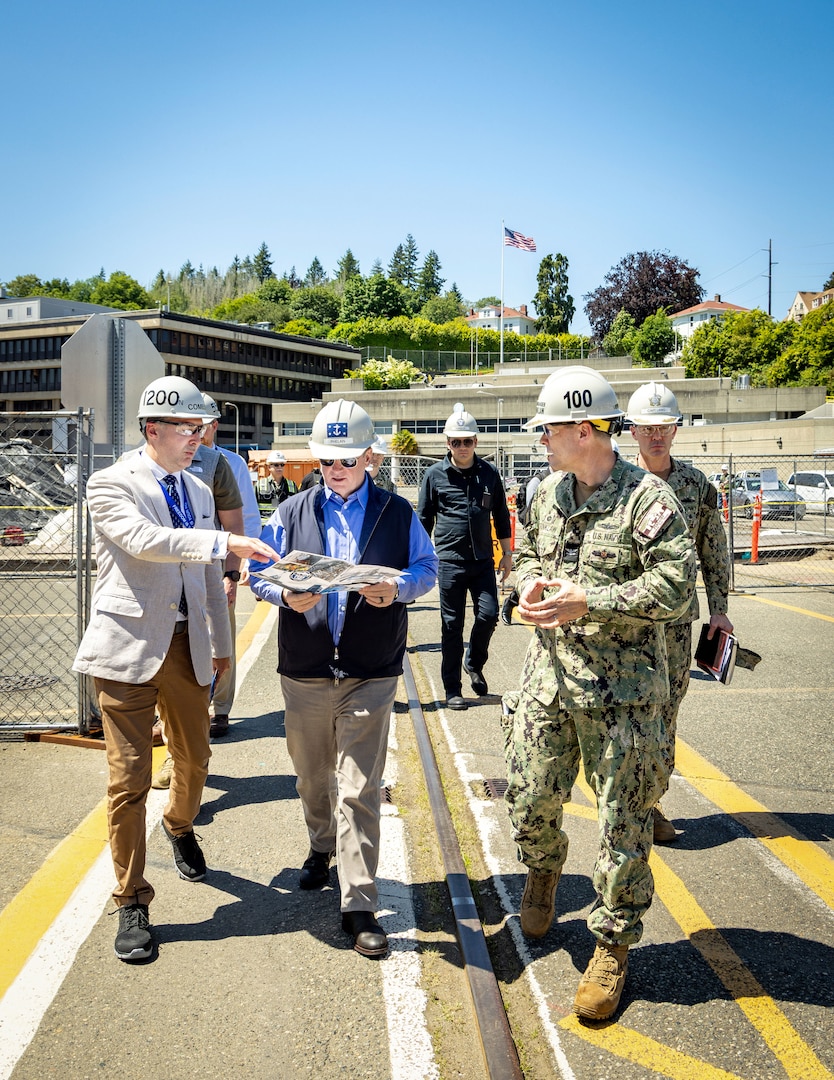 Secretary of the Navy John C. Phelan, received a brief on shipyard operations from Charlie Combs, nuclear business manager, Code 1200N, Nuclear Business Office, and Capt. JD Crinklaw, commander, Puget Sound Naval Shipyard & Intermediate Maintenance Facility, May 28, 2025, in Bremerton, Washington. (U.S. Navy photo by Wendy Hallmark)