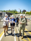 Secretary of the Navy John C. Phelan, received a brief on shipyard operations from Charlie Combs, nuclear business manager, Code 1200N, Nuclear Business Office, and Capt. JD Crinklaw, commander, Puget Sound Naval Shipyard & Intermediate Maintenance Facility, May 28, 2025, in Bremerton, Washington. (U.S. Navy photo by Wendy Hallmark)