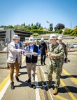 Secretary of the Navy John C. Phelan, received a brief on shipyard operations from Charlie Combs, nuclear business manager, Code 1200N, Nuclear Business Office, and Capt. JD Crinklaw, commander, Puget Sound Naval Shipyard & Intermediate Maintenance Facility, May 28, 2025, in Bremerton, Washington. (U.S. Navy photo by Wendy Hallmark)