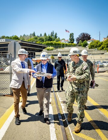 Secretary of the Navy John C. Phelan, received a brief on shipyard operations from Charlie Combs, nuclear business manager, Code 1200N, Nuclear Business Office, and Capt. JD Crinklaw, commander, Puget Sound Naval Shipyard & Intermediate Maintenance Facility, May 28, 2025, in Bremerton, Washington. (U.S. Navy photo by Wendy Hallmark)