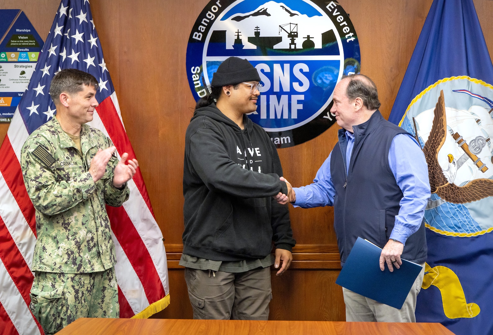 Secretary of the Navy John C. Phelan presents the Navy Superior Civilian Medal for Valor to Mario Arsenio Jr., shipfitter, Shop 11/17, Shipfitters, May 28, 2025, during Phelan’s visit to Puget Sound Naval Shipyard & Intermediate Maintenance Facility in Bremerton, Washington. (U.S. Navy photo by Wendy Hallmark)