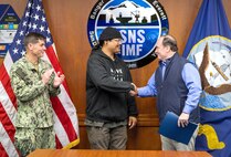 Secretary of the Navy John C. Phelan presents the Navy Superior Civilian Medal for Valor to Mario Arsenio Jr., shipfitter, Shop 11/17, Shipfitters, May 28, 2025, during Phelan’s visit to Puget Sound Naval Shipyard & Intermediate Maintenance Facility in Bremerton, Washington. (U.S. Navy photo by Wendy Hallmark)