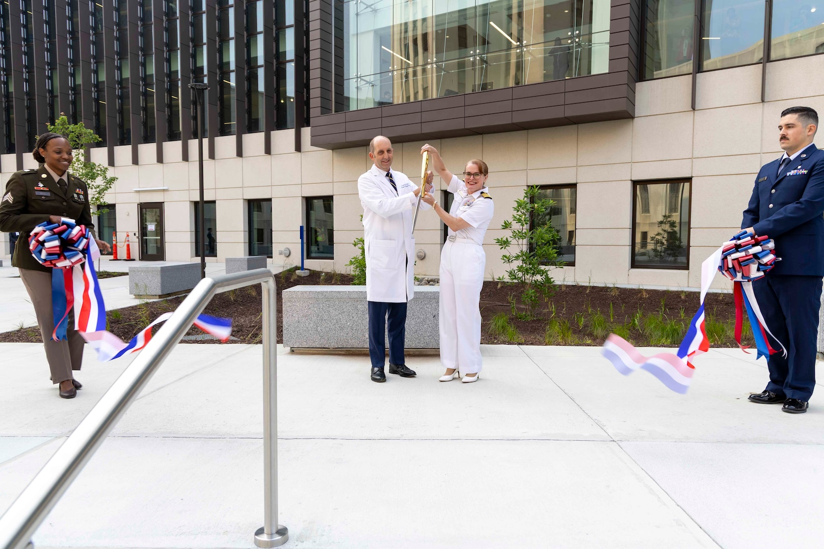 U.S. Navy Capt. Melissa Austin, Director of Walter Reed National Military Medical Center, and Dr. Stephen Ferrara, Acting Assistant Secretary of Defense for Health Affairs, cut the ribbon at the Roosevelt Pavilion Opening Ceremony at Walter Reed, Bethesda, Md., June 3. The new 530,000 square foot, state-of-the-art facility enhances Walter Reed’s ability to provide advanced, patient-centered care for service members and their families. (DOD photo by Roan Smith)