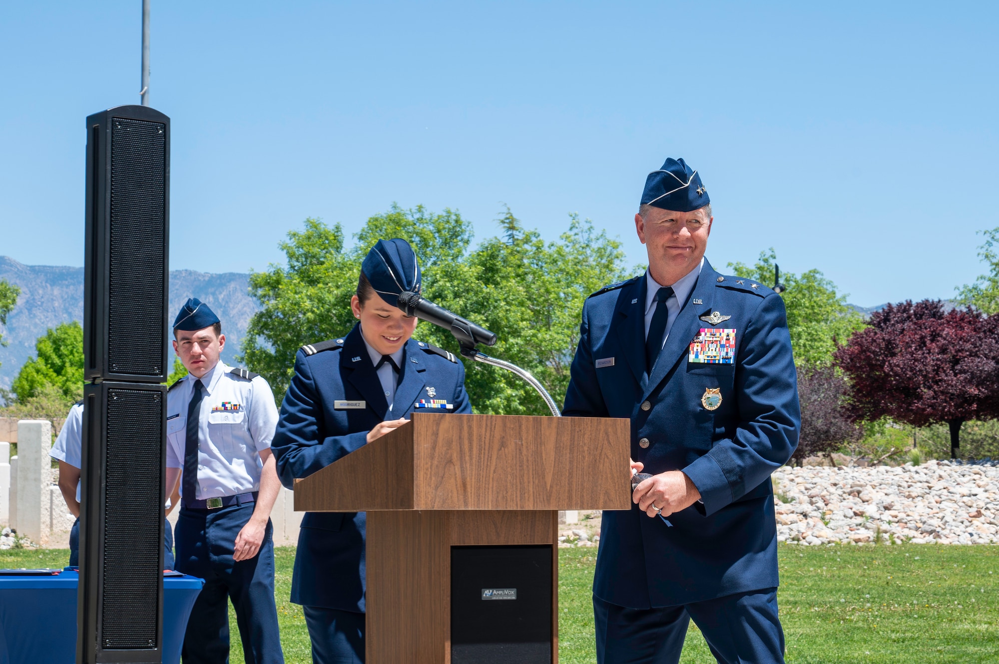 Servicemembers at podium in blues uniform