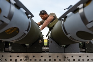 An Airman assigned to the 393rd Bomber Generation Squadron prepares GBU-38 Joint Direct Attack Munitions to be loaded onto a B-2 Spirit stealth bomber at Whiteman Air Force Base, Mo. The loading operations were a component of the Air Force Research Laboratory QUICKSINK Joint Capability Technology Demonstration, a new low-cost, air-delivered capability for defeating maritime threats. (U.S. Air Force photo by Senior Airman Joshua Hastings)