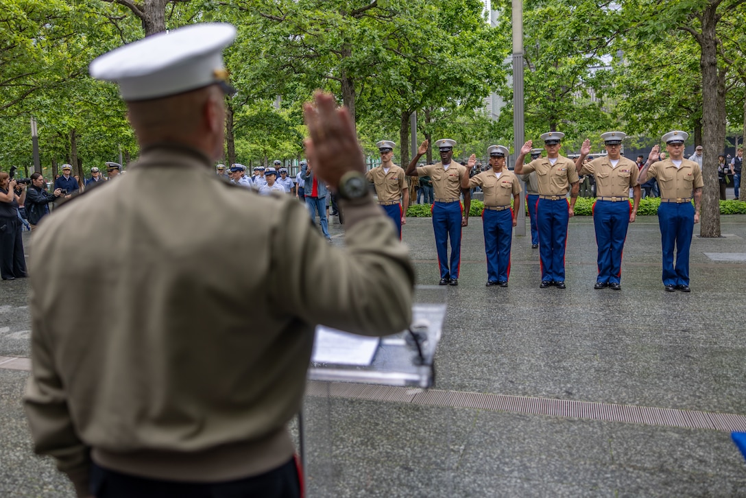 U.S. Marines with Special Purpose Marine Air-Ground Task Force - Fleet Week New York, recite the oath of enlistment during a re-enlistment ceremony held at the 9/11 Memorial as part of Fleet Week New York, May 23, 2025. America’s warfighting Navy and Marine Corps celebrate 250 years of protecting American prosperity and freedom. Fleet Week New York 2025 honors the Navy, Marine Corps, and Coast Guard’s enduring role on, under, and above the seas. (U.S. Marine Corps photo by Cpl. Christian Salazar)