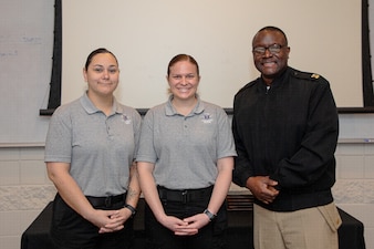250306-N-KC192-1003 SPRING LAKE, N.C. (Mar. 6, 2025) - Hospital Corpsman 3rd Class Rebeccah Cisneros, an aerospace medical technician assigned to Navy Medicine Readiness and Training Command (NMRTC) Guam, Hospital Corpsman 2nd Class Kelly Jurkouich, a branch clinic assistant leading petty officer assigned to Expeditionary Medical Facility (EMF) Mike, and Naval Medical Forces Atlantic Command Master Chief Lamar Bethel take a photo before a paramedic course graduation ceremony at Fayetteville Technical Community College, Mar. 6, 2025. The primary purpose of the 20-week military paramedic course at Fayetteville Technical Community College in Spring Lake, North Carolina is to expand the skills of service members, and increase survivability of those in harm’s way. Navy Medicine is enhancing Expeditionary Medical Unit (EXMED) capabilities by equipping Hospital Corpsmen with advanced trauma and pre-hospital care skills through an accelerated paramedic training program. This intensive five-month course ensures corpsmen are prepared to deliver life-sustaining care in austere environments, strengthening the Navy’s ability to support warfighters in operational settings worldwide. (U.S. Navy photo by Mass Communication Specialist 2nd Class Levi Decker)