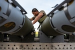 An Airman assigned to the 393rd Bomber Generation Squadron prepares GBU-38 Joint Direct Attack Munitions to be loaded onto a B-2 Spirit stealth bomber at Whiteman Air Force Base, Mo. The loading operations were a component of the Air Force Research Laboratory QUICKSINK Joint Capability Technology Demonstration, a new low-cost, air-delivered capability for defeating maritime threats. (U.S. Air Force photo by Senior Airman Joshua Hastings)