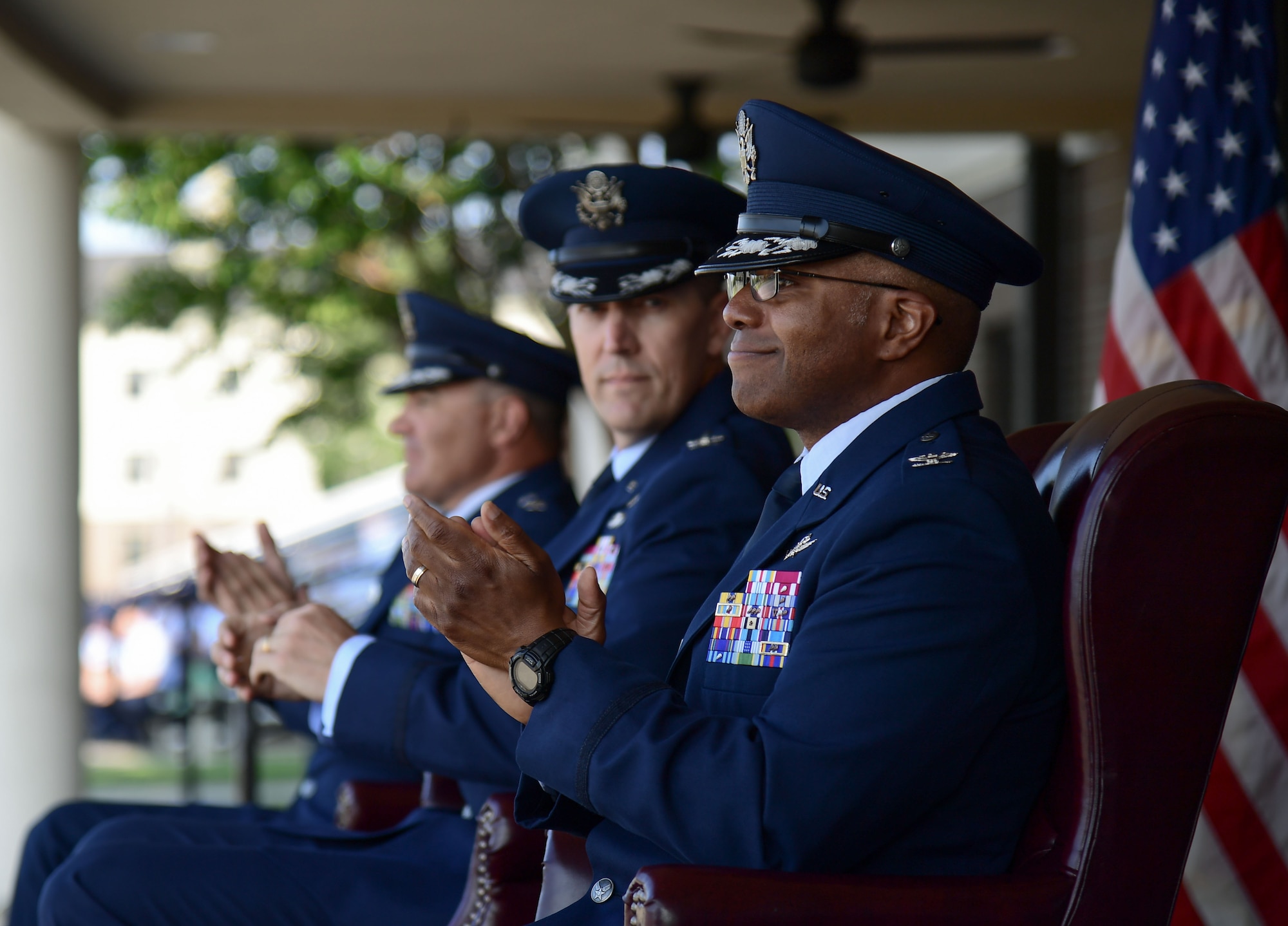 Airmen sitting and clapping.
