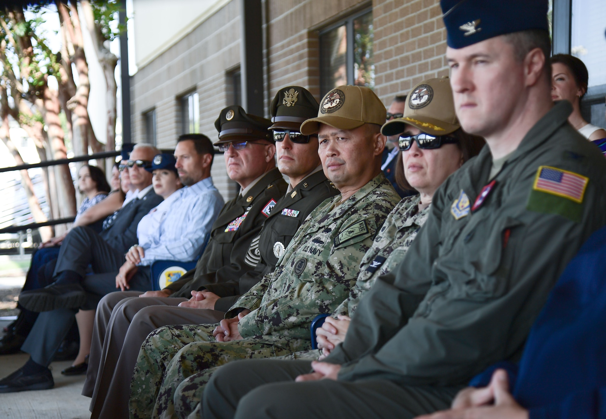 People sitting watching a speech.