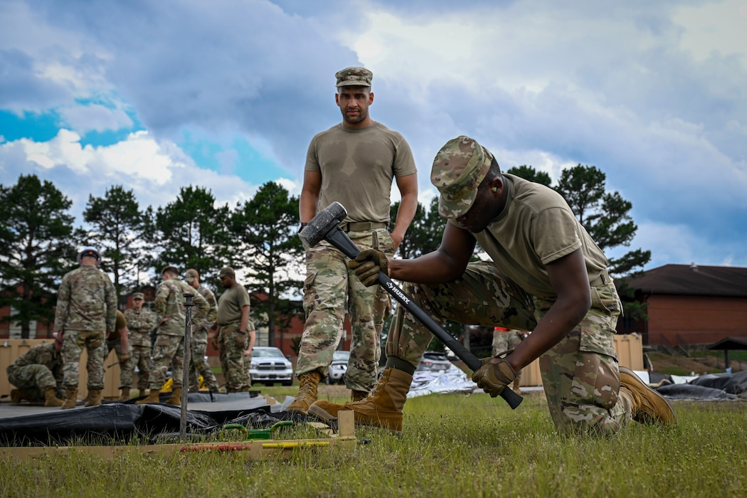 An Airman constructs a Small Shelter System tent.