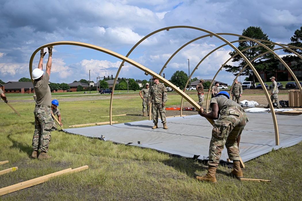 Airmen construct a Small Shelter System tent.
