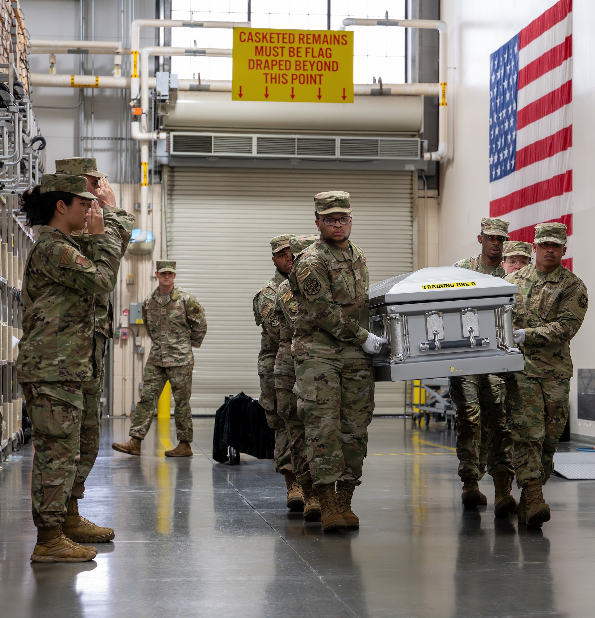 Airmen with the 436th Mission Generation Group carry a casket during their final evaluation for reverse dignified transfer training