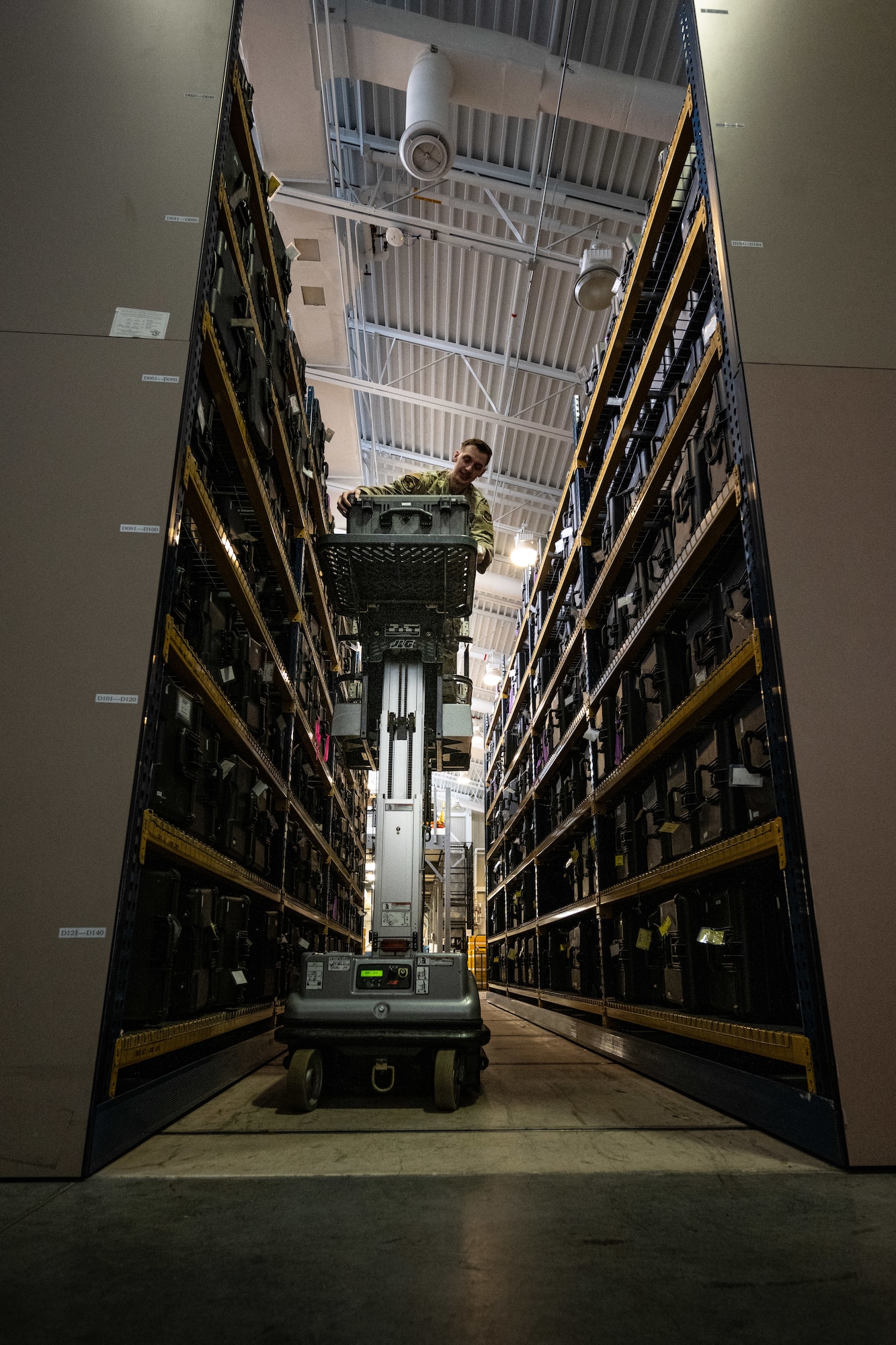 U.S. Air Force Senior Airman Arthur Fetterhoff, 436th Operations Support Squadron Aircrew Flight Equipment journeyman, pulls a case off a shelf at Dover Air Force Base, Delaware, June 3, 2025. The AFE team provides inspections and maintenance for flight safety equipment such as aircrew oxygen masks, parachutes, emergency escape slides and life rafts for the C-5M Super Galaxy and C-17 Globemaster III. (U.S. Air Force photo by Staff Sgt. Marco A. Gomez)