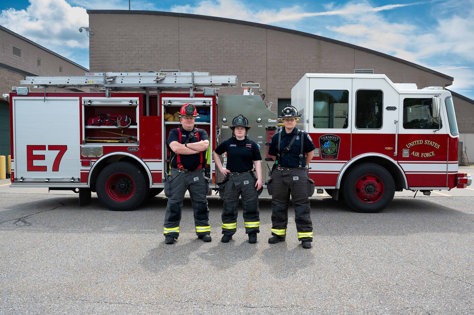 U.S. Air National Guard civilian firefighters, assigned to the Vermont Air National Guard Fire Department, pose in front of the fire truck that was the first on scene, South Burlington, VT, June 4, 2025.