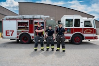 U.S. Air National Guard civilian firefighters, assigned to the Vermont Air National Guard Fire Department, pose in front of the fire truck that was the first on scene, South Burlington, VT, June 4, 2025.