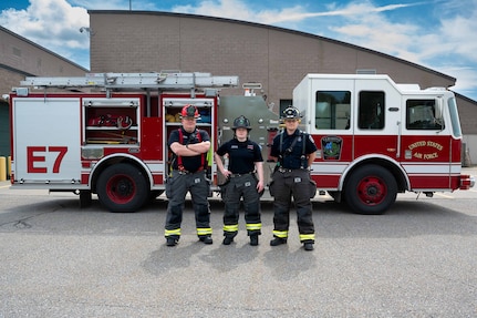 U.S. Air National Guard civilian firefighters, assigned to the Vermont Air National Guard Fire Department, pose in front of the fire truck that was the first on scene, South Burlington, VT, June 4, 2025.