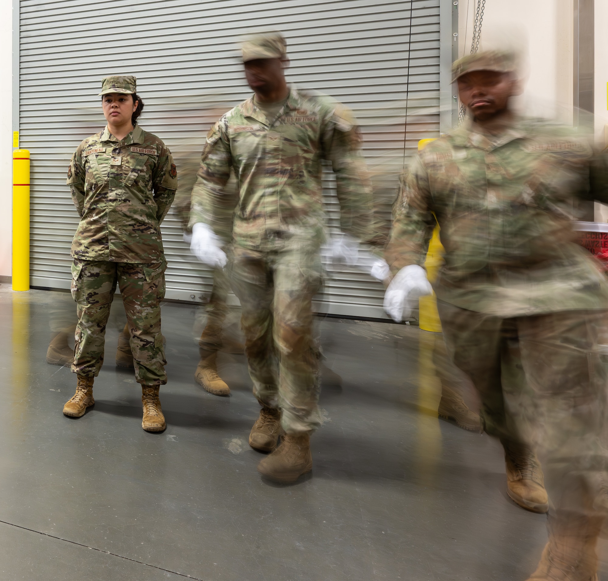Airmen with the 436th Mission Generation Group march to retrieve a casket during their final evaluation for reverse dignified transfer training