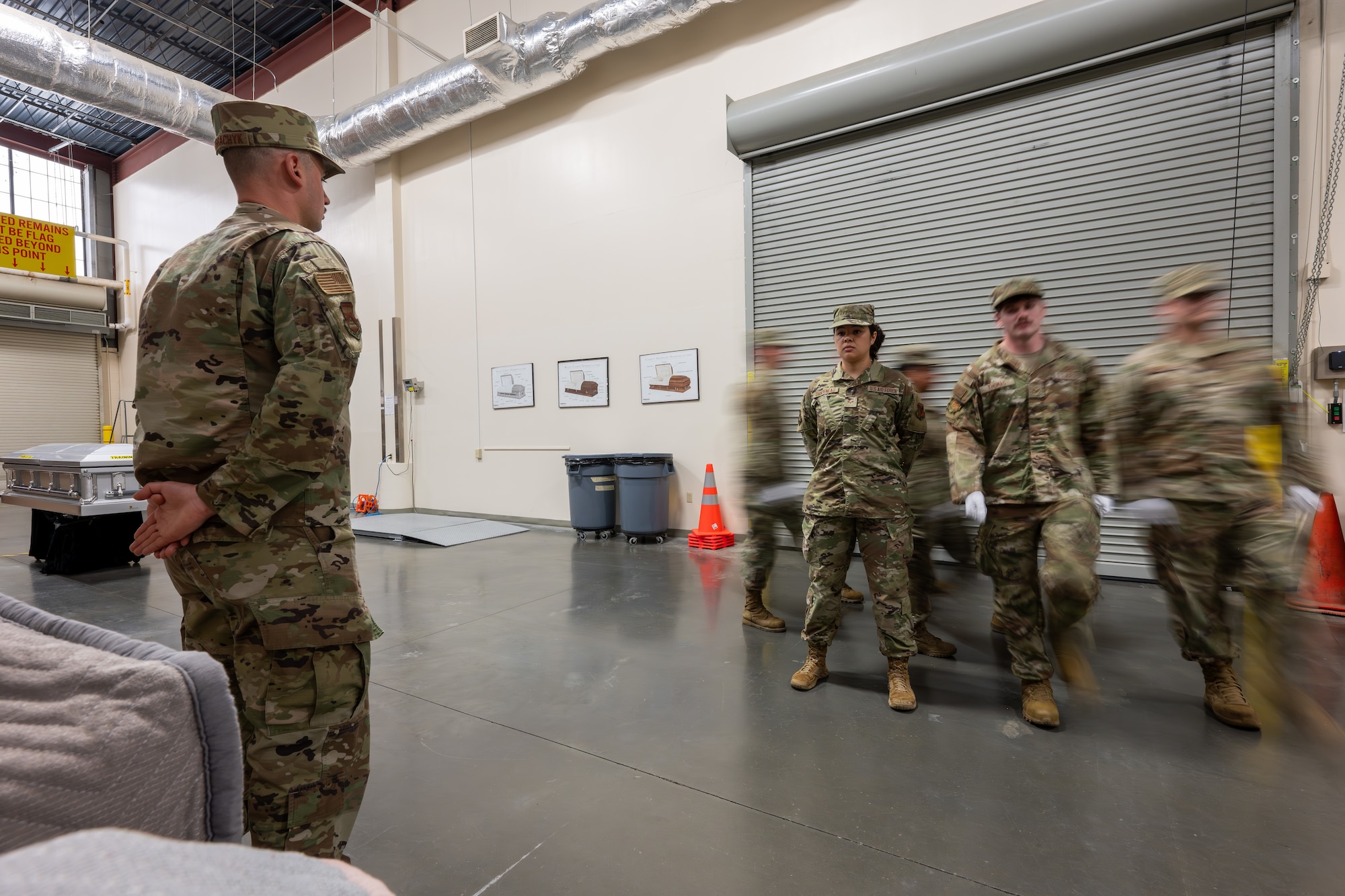 436th Mission Generation Group march to retrieve a casket during their final evaluation for reverse dignified transfer training