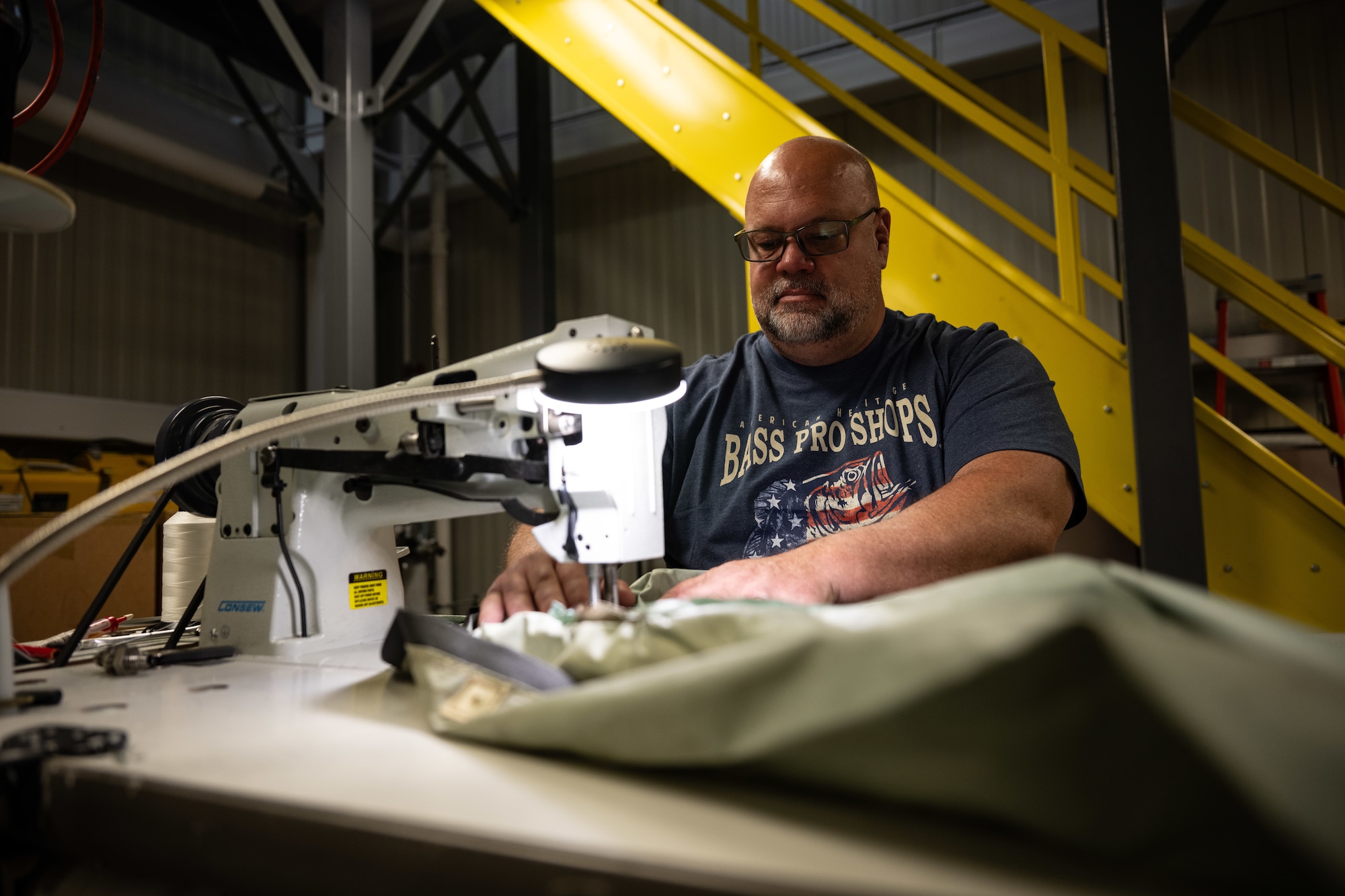 Jamey Schafer, 436th Operations Support Squadron Aircrew Flight Equipment technician, sews a liner at Dover Air Force Base, Delaware, June 3, 2025. The AFE team provides inspections and maintenance for flight safety equipment such as aircrew oxygen masks, parachutes, emergency escape slides and life rafts for the C-5M Super Galaxy and C-17 Globemaster III. (U.S. Air Force photo by Staff Sgt. Marco A. Gomez)