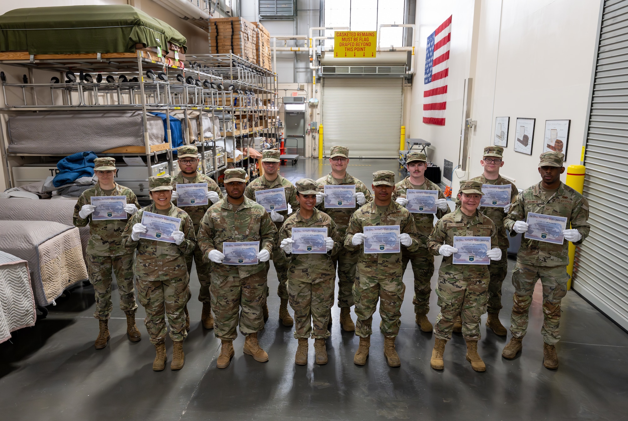 Airmen pose for a group photo with their certificates
