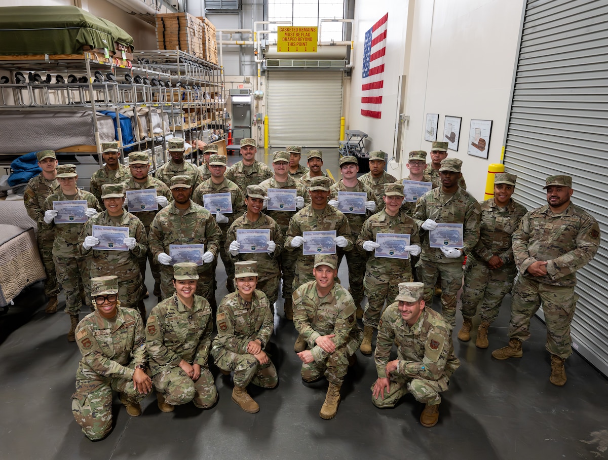 Airmen pose for a group photo with their certificates