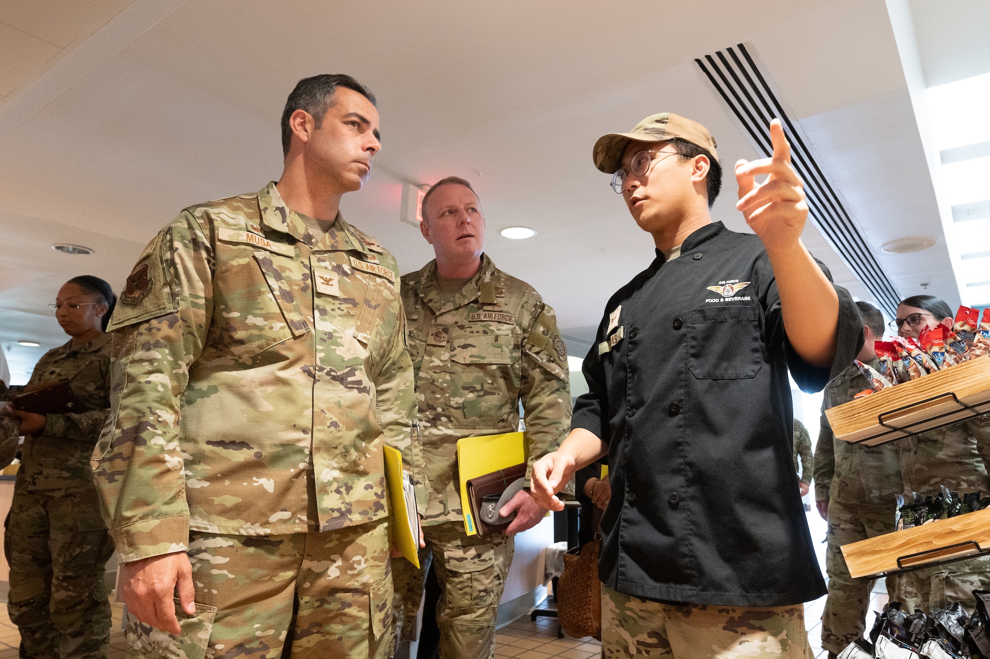 U.S. Air Force Col. Jamil Musa, left, 436th Airlift Wing commander, and Chief Master Sgt. Elijah Edwards, center, 436th AW command chief, walk through the Patterson Dining Facility during a command team immersion tour at Dover Air Force Base, Delaware, June 3, 2025. The new command team toured various units within the 436th Mission Support Group to familiarize themselves with their mission and capabilities. (U.S. Air Force photo by Mauricio Campino)