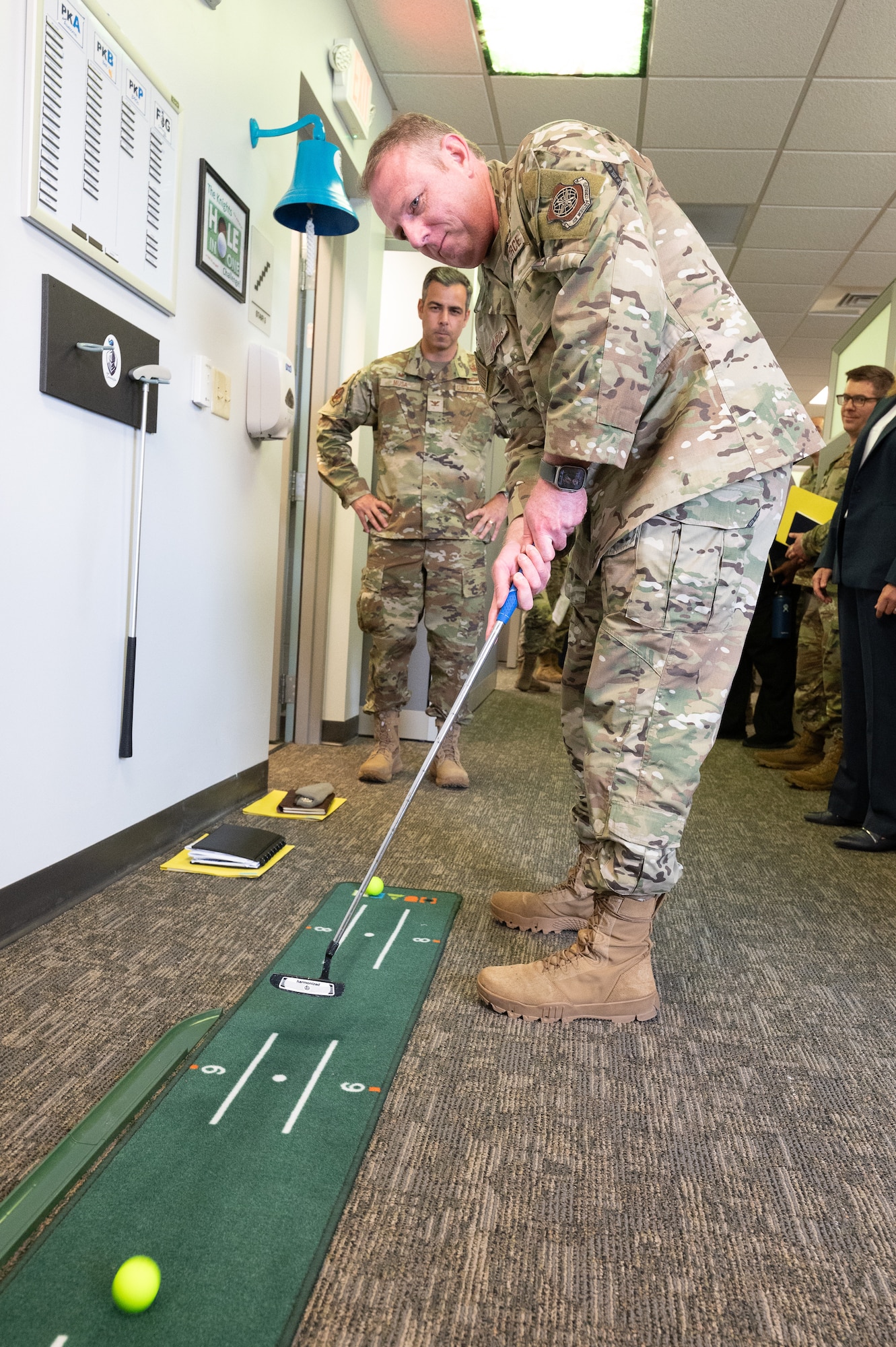 U.S. Air Force Chief Master Sgt. Elijah Edwards, 436th Airlift Wing command chief, putts a golf ball while visiting the 436th Contracting Squadron office during a command team immersion tour at Dover Air Force Base, Delaware, June 3, 2025. The new command team toured various units within the 436th Mission Support Group to familiarize themselves with their mission and capabilities. (U.S. Air Force photo by Mauricio Campino)