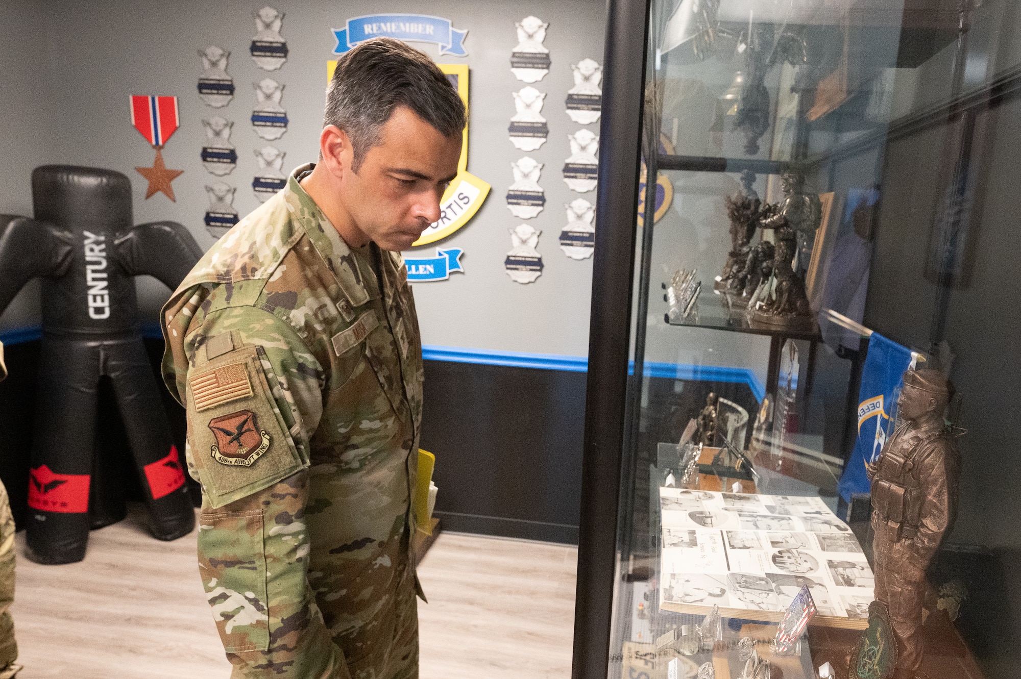 U.S. Air Force Col. Jamil Musa, 436th Airlift Wing commander, looks at a display case featuring military memorabilia while visiting the 436th Security Forces Squadron office during a command team immersion tour at Dover Air Force Base, Delaware, June 3, 2025. The new command team toured various units within the 436th Mission Support Group to familiarize themselves with their mission and capabilities. (U.S. Air Force photo by Mauricio Campino)