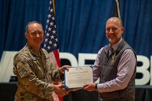 U.S. Space Force Col. Mark Shoemaker, Space Launch Delta 30 commander, left, presents the meritorious civilian service award to Tom Stevens, Space Launch Delta 30 executive director, during a commander’s call at Vandenberg Space Force Base, Calif., June 3, 2025. During the all-call, Shoemaker, along with other SLD 30 leadership, highlighted the achievements of the Guardians and Airmen on the installation over the course of Shoemaker’s command and the execution of the Delta’s strategic objectives.