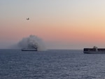 A Coast Guard C-130J Super Hercules aircrew from Air Station Kodiak conducts an overflight of a fire aboard the cargo vessel Morning Midas approximately 300 miles south of Adak, Alaska, June 3, 2025.