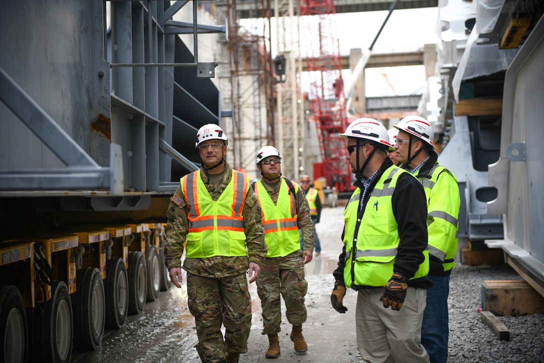 Lt. Gen. William "Butch" Graham (front left), commanding general of the U.S. Army Corps of Engineers and 56th chief of engineers, walks with Allen Malcomb (front right), chief of quality assurance for the Chickamauga Lock Replacement Project, at the bottom of the new lock chamber between two miter gates during a site visit on Dec. 19, 2024, in Chattanooga, Tenn., along the Tennessee River. (U.S. Army Corps of Engineers photo by Noe Gonzalez)