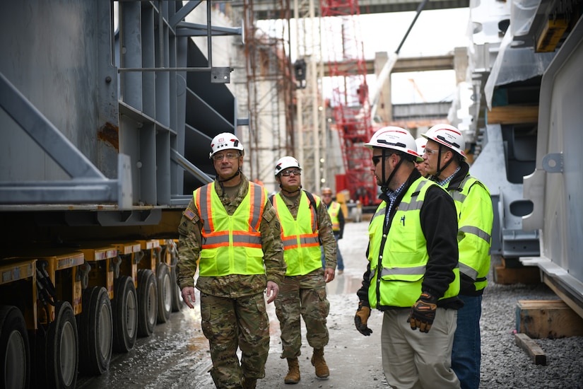 Lt. Gen. William "Butch" Graham (front left), commanding general of the U.S. Army Corps of Engineers and 56th chief of engineers, walks with Allen Malcomb (front right), chief of quality assurance for the Chickamauga Lock Replacement Project, at the bottom of the new lock chamber between two miter gates during a site visit on Dec. 19, 2024, in Chattanooga, Tenn., along the Tennessee River. (U.S. Army Corps of Engineers photo by Noe Gonzalez)