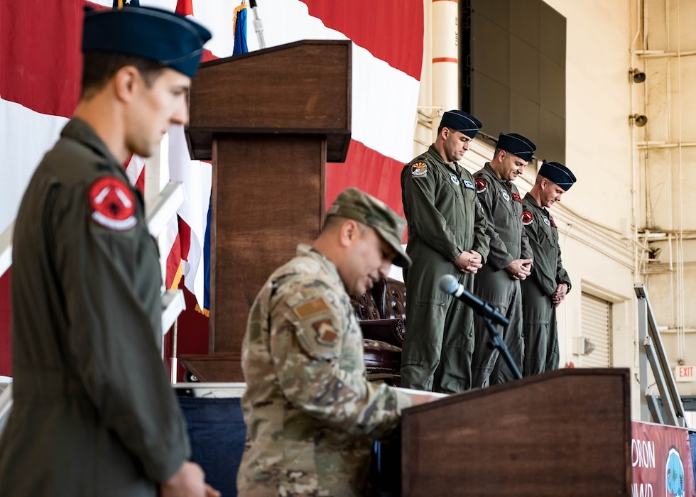 U.S. Air Force key leadership assigned to the 56th Fighter Wing bow their heads in prayer at the 425th Fighter Squadron Change of Command Ceremony