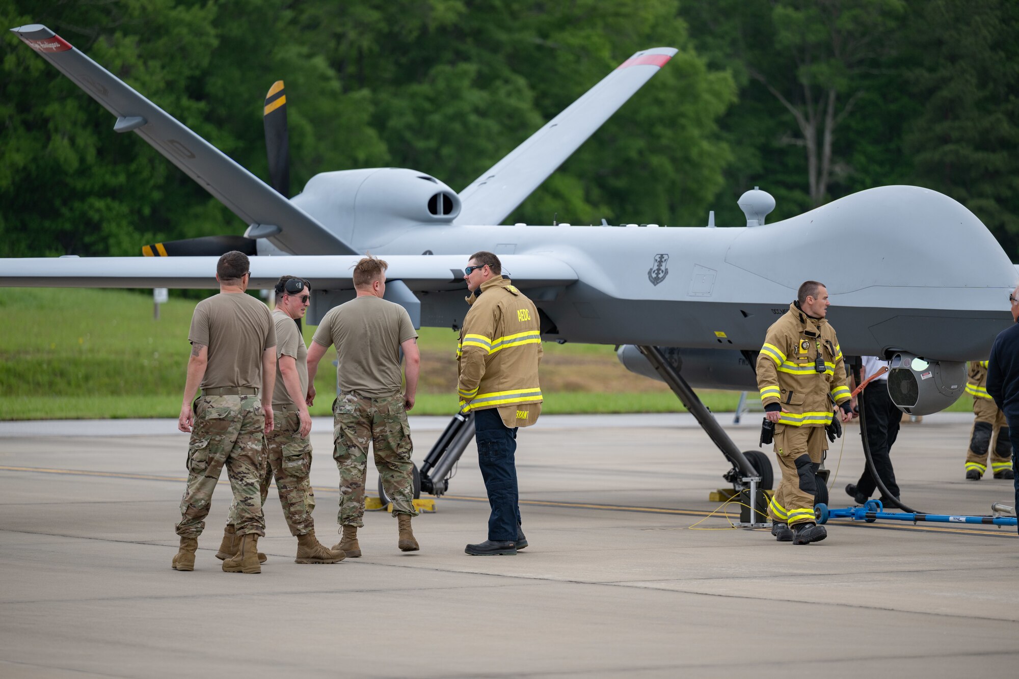 Aircraft Rescue and Fire Fighting crews from Arnold Air Force Base Fire and Emergency Services are familiarized with the MQ-9 Reaper during the portion of the Vigilant Guard exercise conducted at Arnold AFB, Tenn., May 14, 2025. Vigilant Guard is an annual disaster response exercise carried out by National Guard units across the country. Arnold AFB was involved in the portion of Vigilant Guard 2025 focused on airfield management and fuel transfer missions. Guardsmen from the Tennessee National Guard and the North Dakota National Guard were on hand at Arnold to perform the exercise. Arnold AFB Fire and Emergency Services crews supported the effort by maintaining a presence during the arrival and departure of aircraft and throughout the refueling. (U.S. Air Force photo by Keith Thornburgh)
