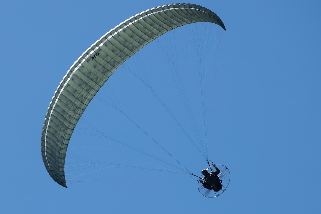 U.S. Marine Corps Staff Sgt. Rob Rueter flies the augmented parachute system during Kaiju Rain 25 at Ie Shima, Okinawa, Japan, April 24, 2025. The APS allows the rapid deployment of Marines and equipment. Exercise Kaiju Rain 25 enhances III Marine Expeditionary Force Information Group’s ability to conduct command and control, employ sensor capabilities and integrate multi-domain operations to enable III MEF, the joint force, and allies and partners in the Indo-Pacific region. Rueter is a parachutist reconnaissance Marine and is a native of California. (U.S. Marine Corps photo by Sgt. William N. Wallace)