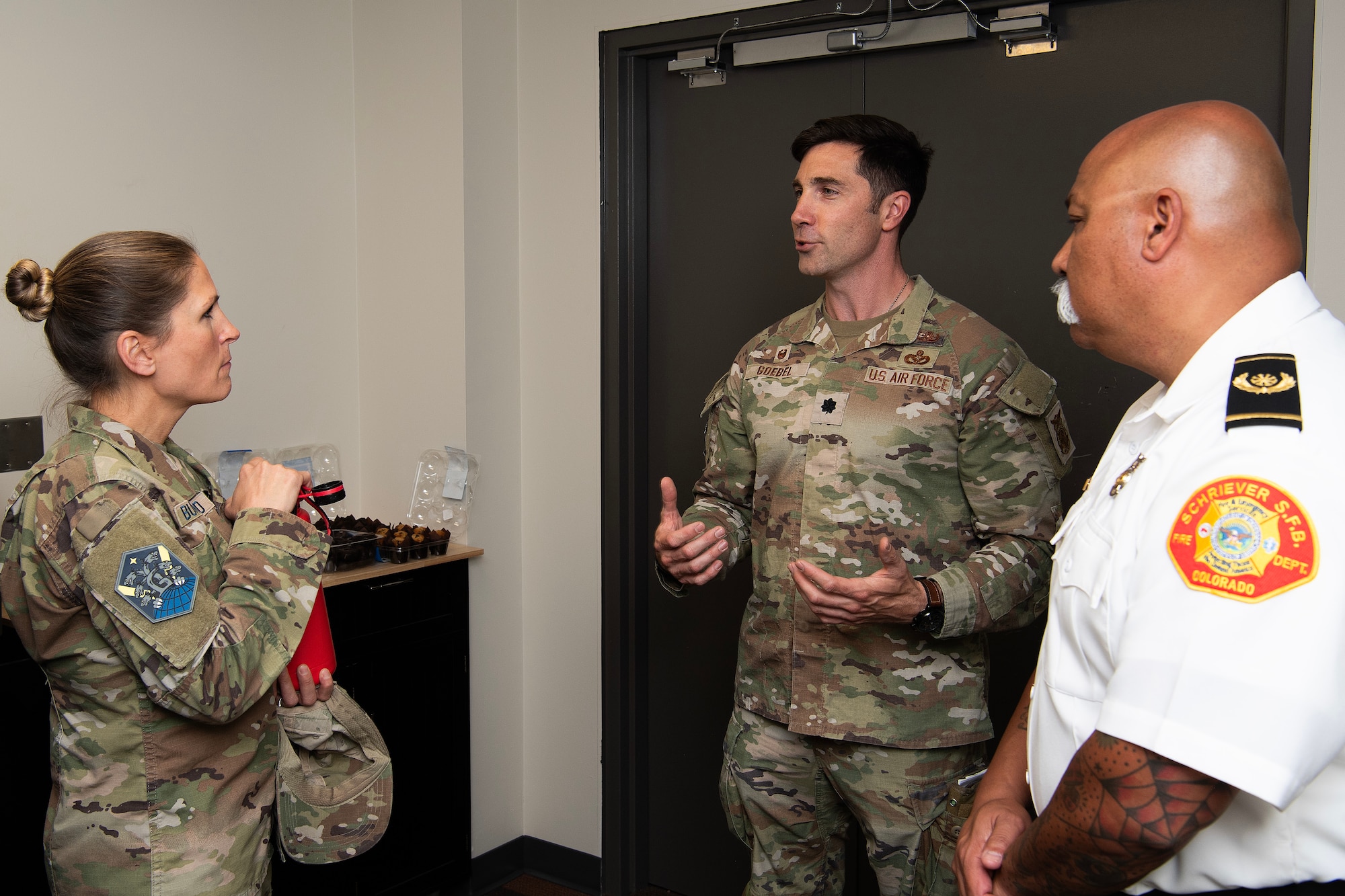 uniformed service members and fire department personnel talking