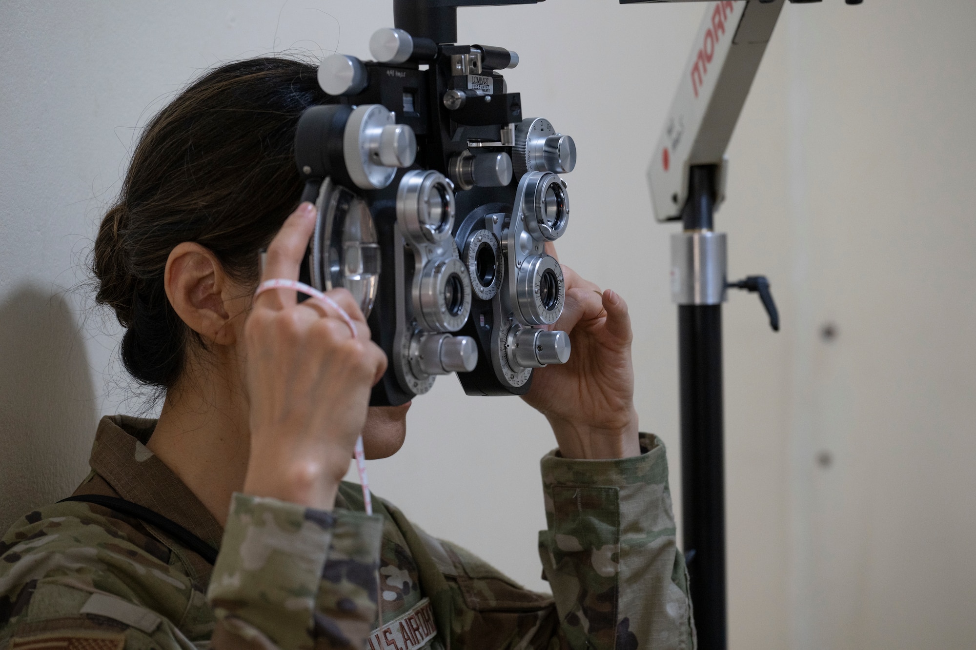U.S. Air Force Maj. Jenny Sung, AMISTAD Optometrist, tests a phoropter in Iquitos, Peru, June 2, 2025. The phoropter is used to measure the glasses prescription level. (U.S. Air Force photo by Senior Airman Victoria Edwards)