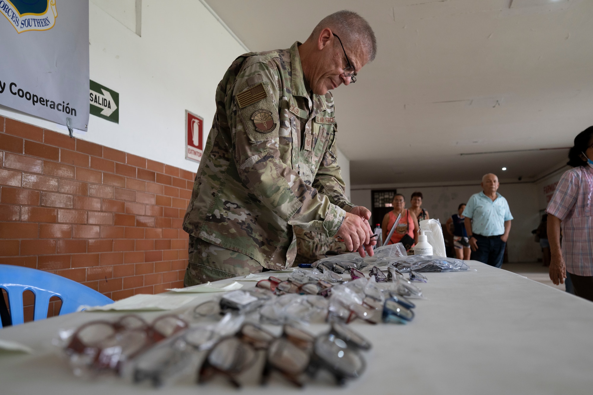 U.S. Air Force Tech. Sgt. Thomas Eckler, AMISTAD Logistics Lead, unpacks prescription eyeglasses for the AMISTAD optometry clinic in Iquitos, Peru, June 2, 2025. Through total force integration, Reserve and Active-Duty Airmen work together and with partners nations to hone skills required for medical and crisis response. (U.S. Air Force photo by Senior Airman Victoria Edwards)