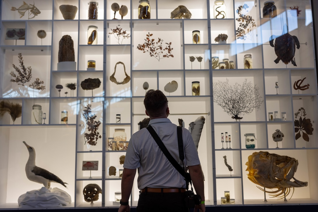 U.S. Marine Corps Lance Cpl. Blake Gonter, combat photographer, Communication Strategy and Operations, U.S. Marine Corps Forces, Pacific, looks at a display at the Bernice Pauahi Bishop Museum, Honolulu, Hawaii, March 31, 2025. MARFORPAC Professional Military Education extends beyond traditional military training to encompass opportunities for Marines to deepen their understanding of the Indo-Pacific region through cultural immersion and historical awareness (U.S. Marine Corps photo by Lance Cpl. Roger-Junior Annoh)