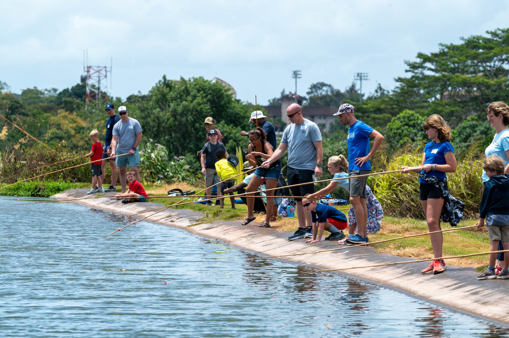 U.S. Air Force families fish at a pond as a recreational day to boost morale.